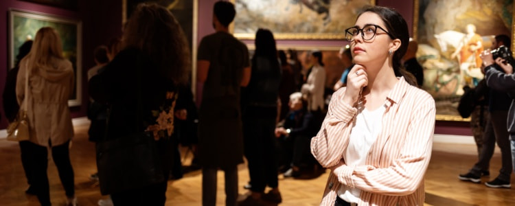 Woman pondering art at a famous art museum